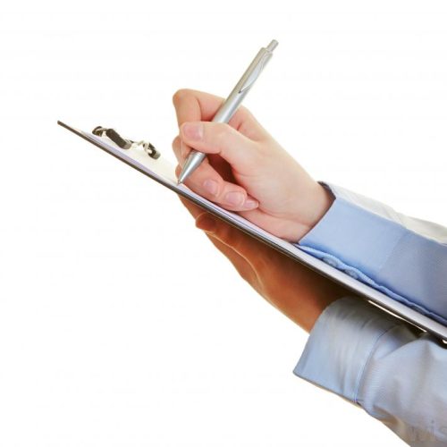 woman-writes-on-paper-on-clipboard